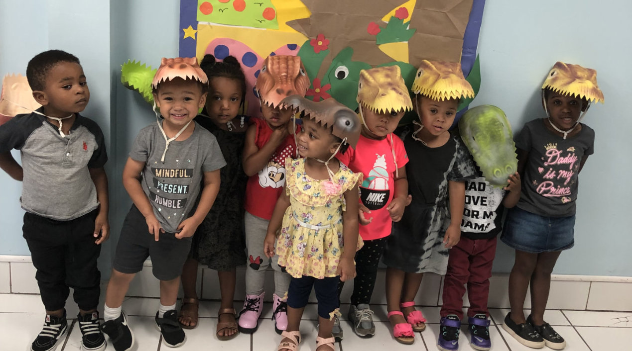 children in dinosaur costumes